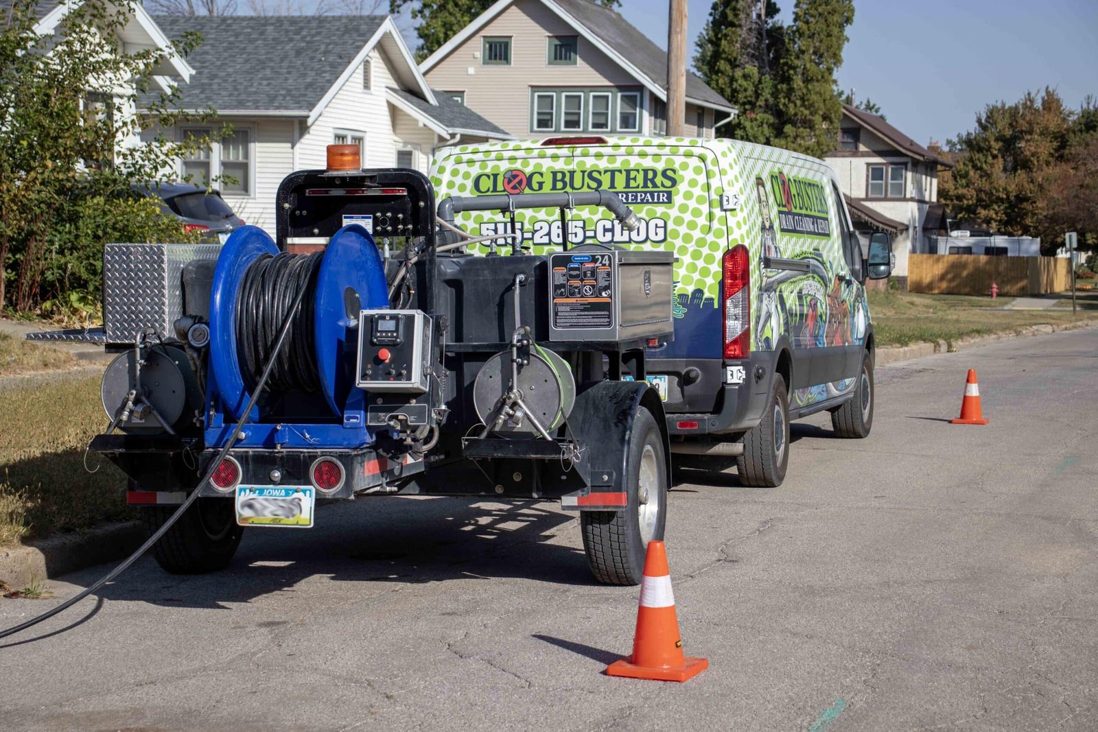 Clog Busters jetter trailer and van staged on a residential street