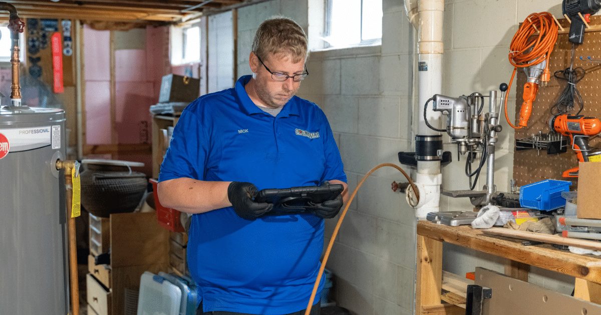 Clog Busters technician with camera gear in a mechanical room