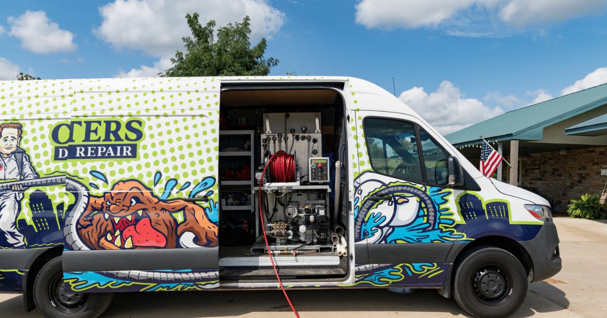 Clog Busters van with rear doors open showing the jetter reel